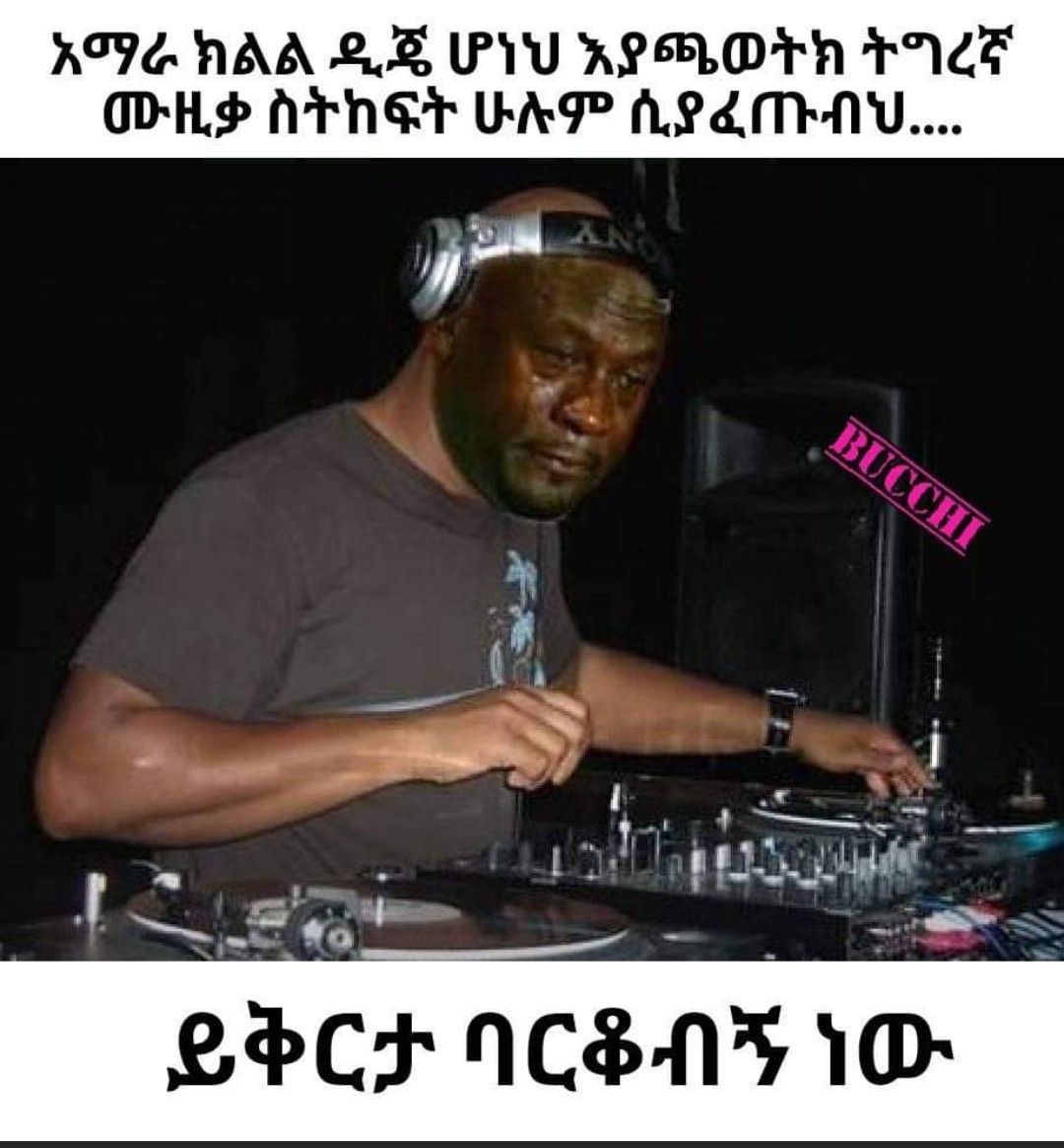 a man in a black shirt and headphones playing a dj